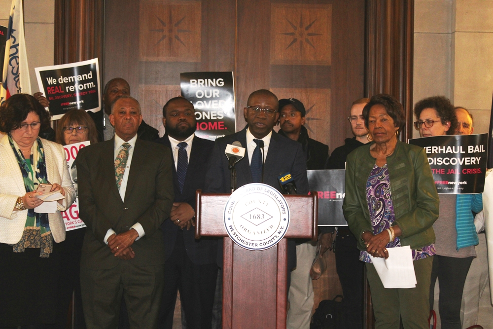 Legislators gathered at podium