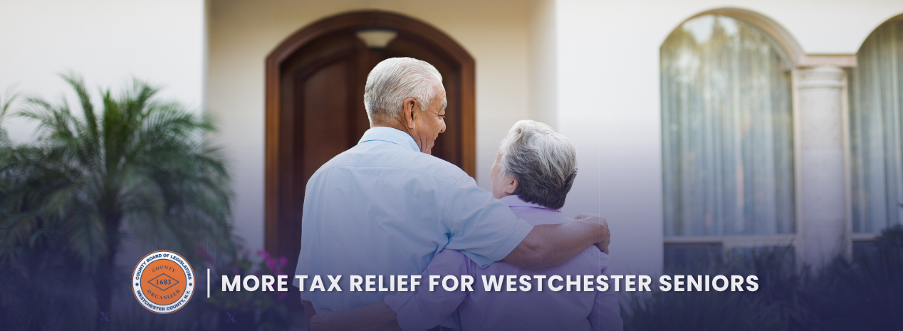 An older man with his arm around an older woman outside a home, representing senior tax relief in Westchester County.
