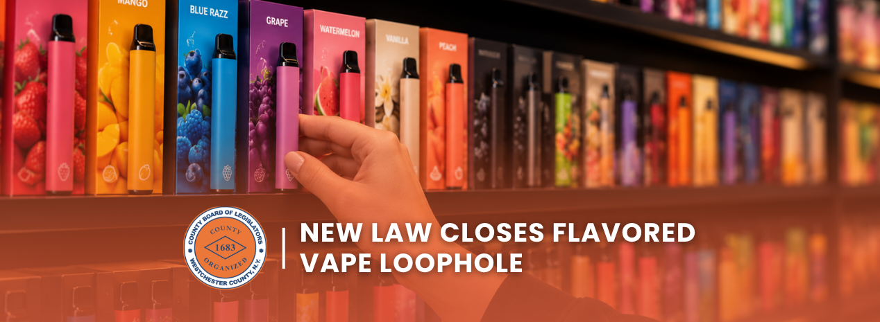 Hand reaching for a colorful flavored vape product displayed on a store shelf.